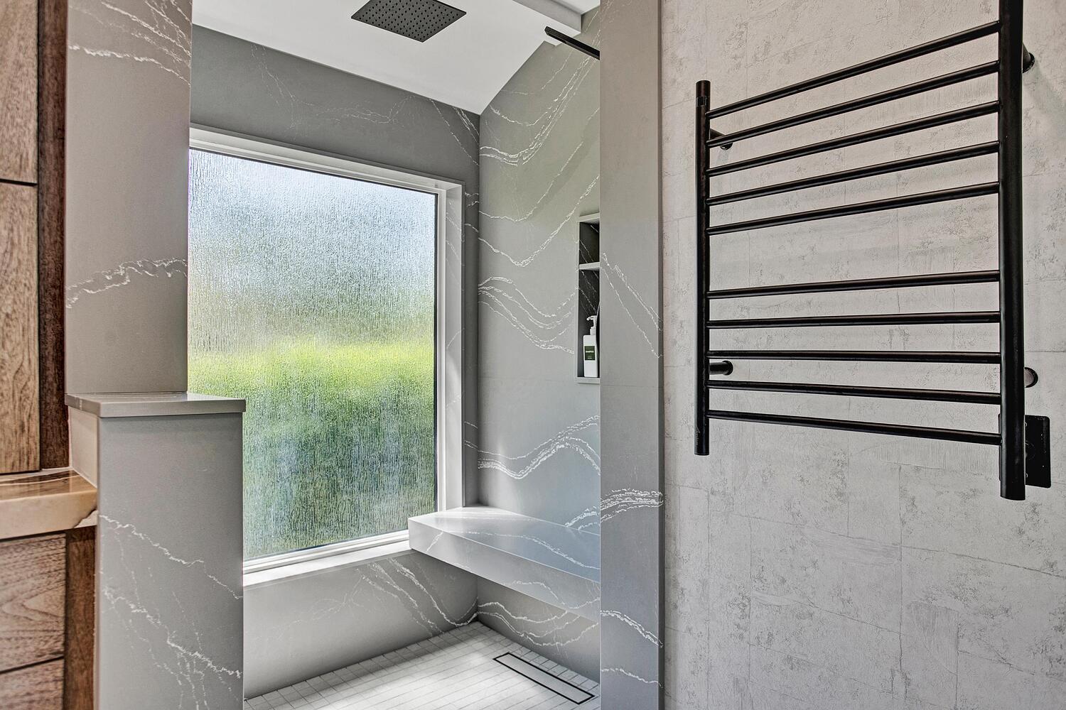 luxury walk-in shower with textured glass window and bench in BeeTree Homes custom home Jacksonville FL luxury walk-in shower with textured glass window and bench in BeeTree Homes custom home Jacksonville FL