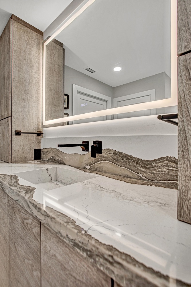 modern bathroom vanity with LED mirror and quartz countertop in BeeTree Homes Jacksonville FL