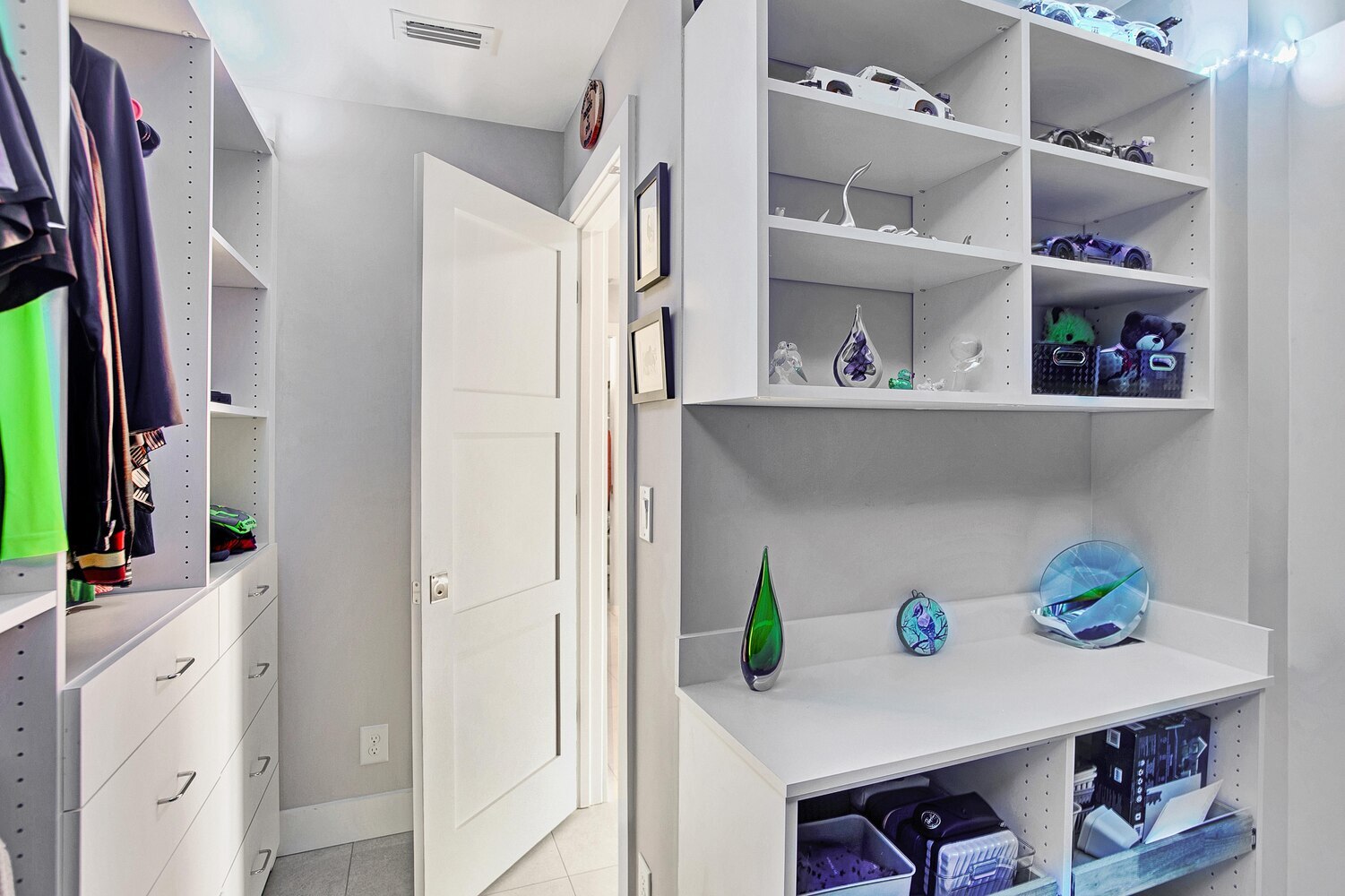 organized closet system with display shelves in BeeTree Homes custom home Ponte Vedra Beach FL