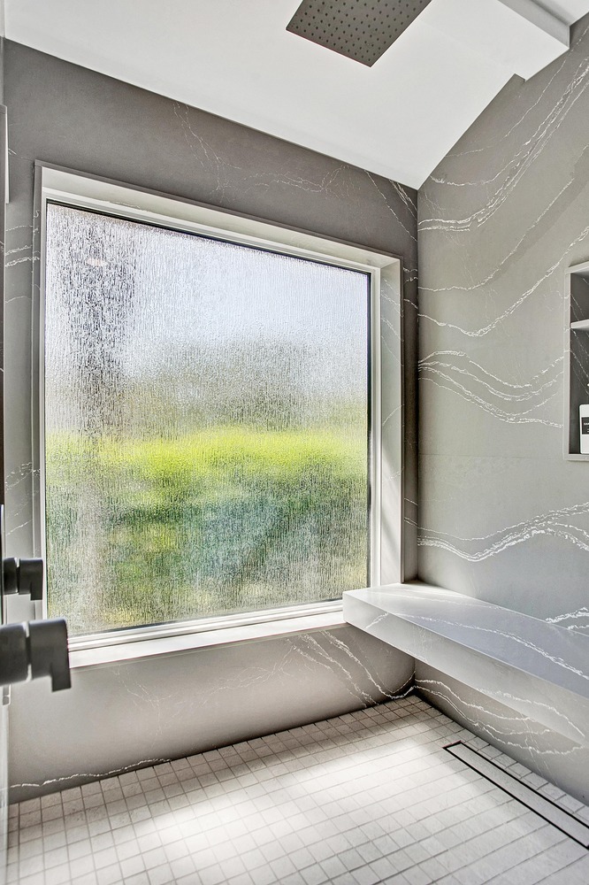 spa-inspired custom home shower with rainfall fixture in BeeTree Homes Atlantic Beach FL