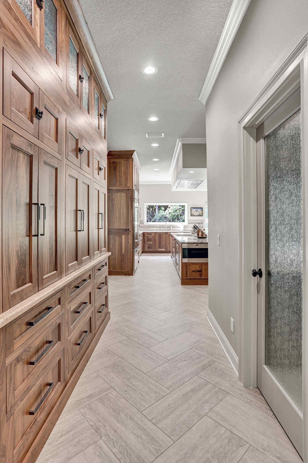 eclectic whole home remodel hallway leading to the kitchen with built-in cabinetry