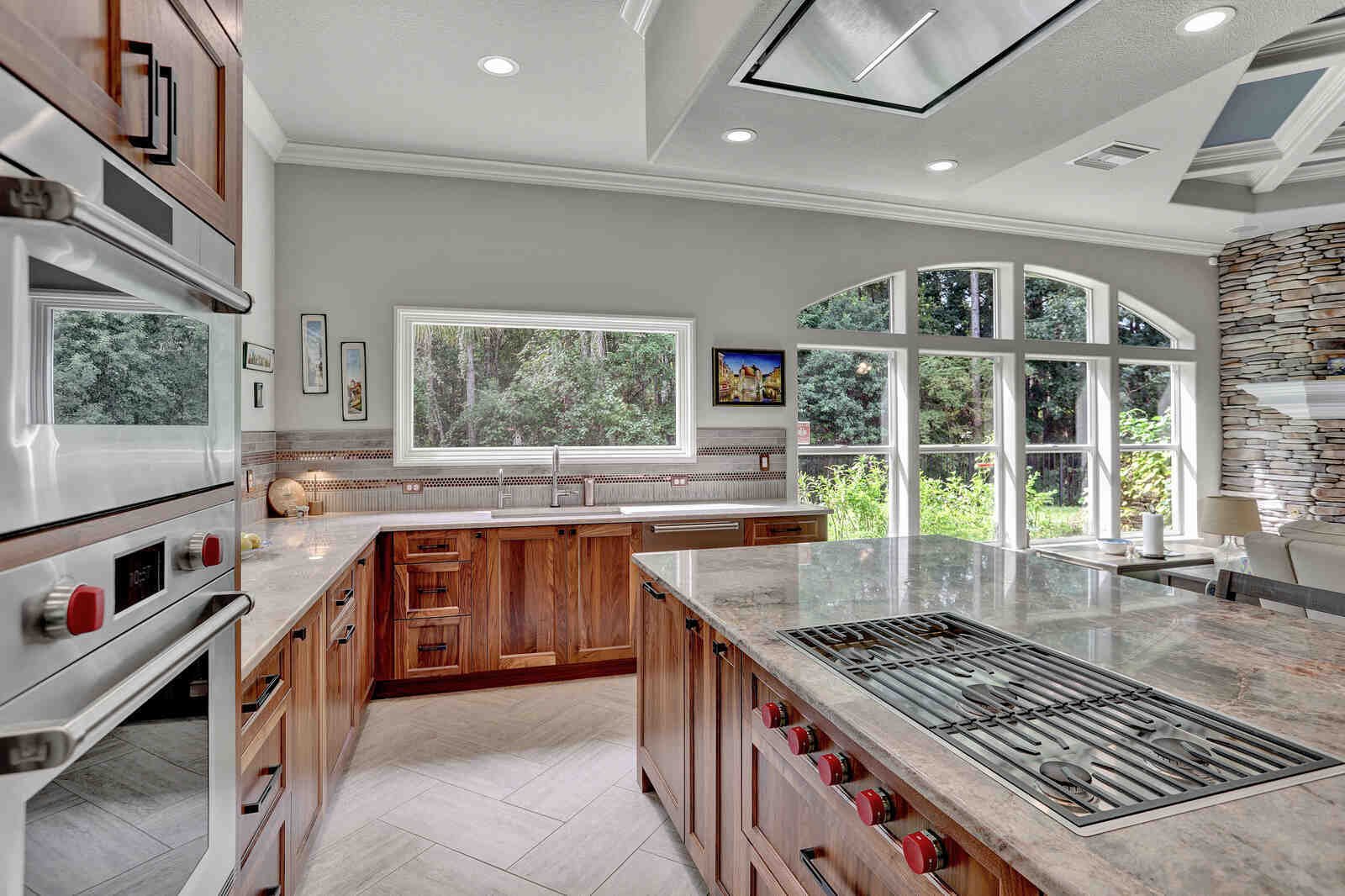 eclectic whole home remodel kitchen island view with gas range and built-in ovens