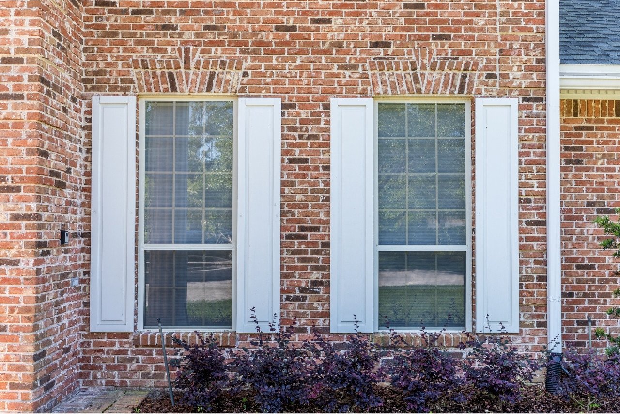 brick home with fresh white shutters in a sawgrass home remodel (1)