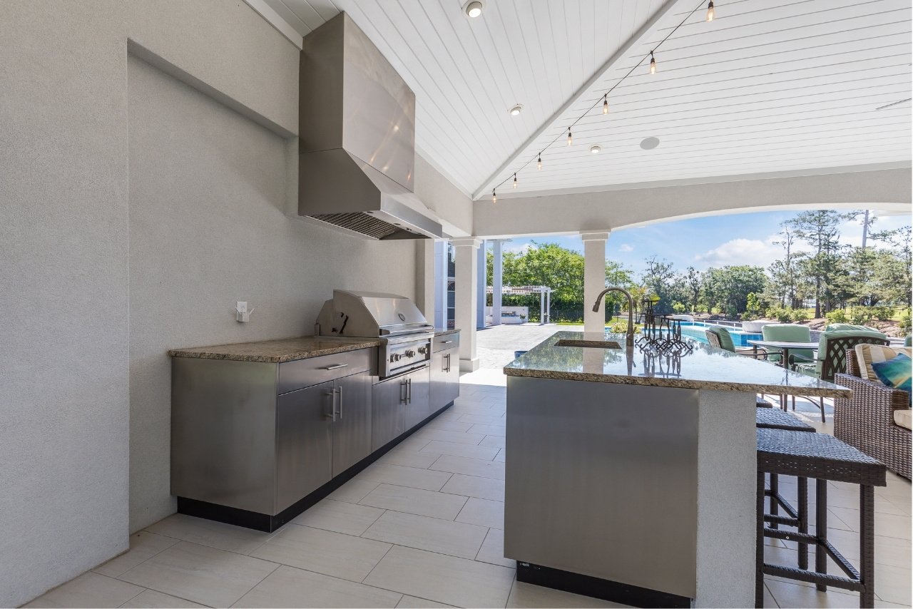 florida outdoor kitchen remodel with island bar seating and pool (1)