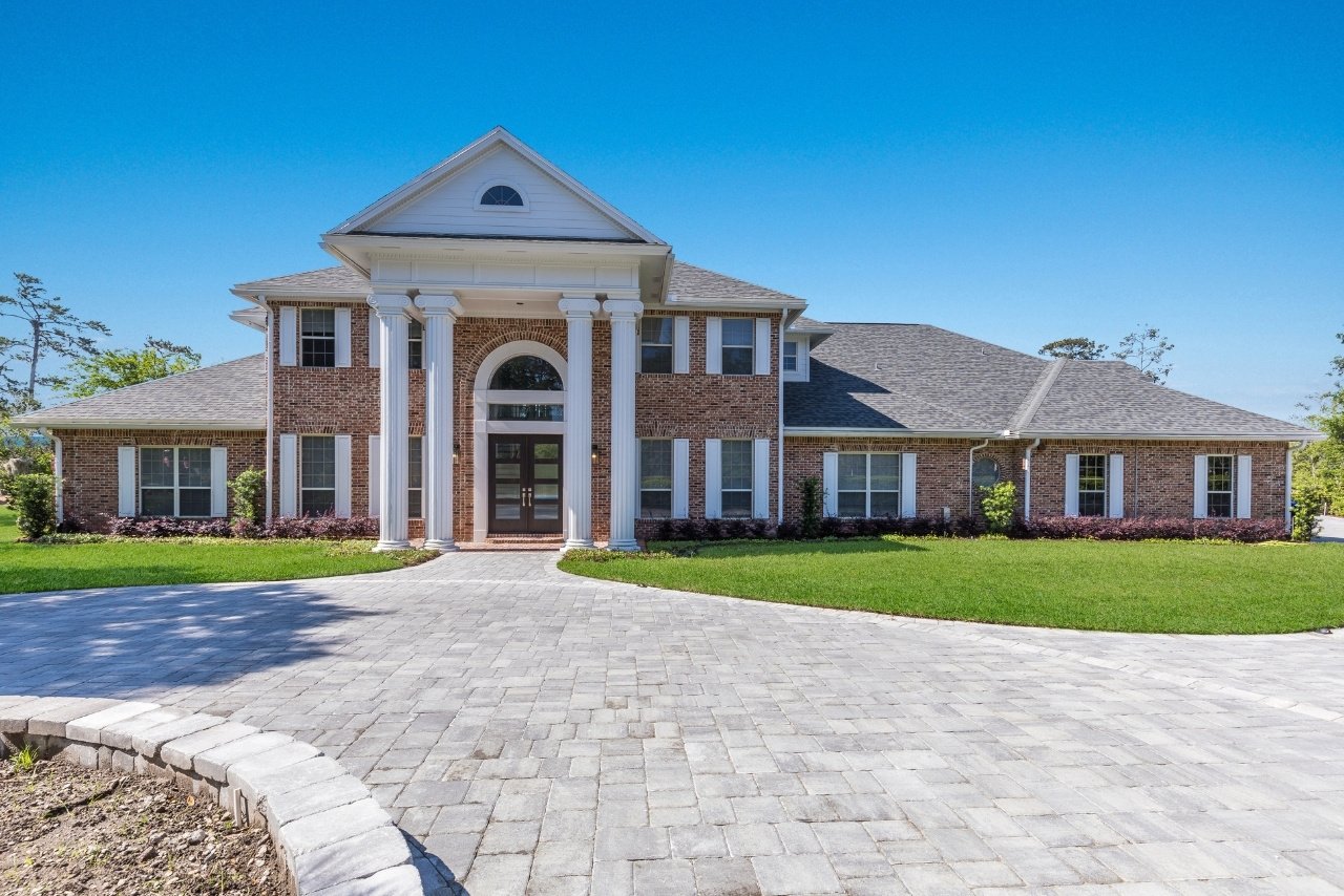 large brick home with stone driveway (1)