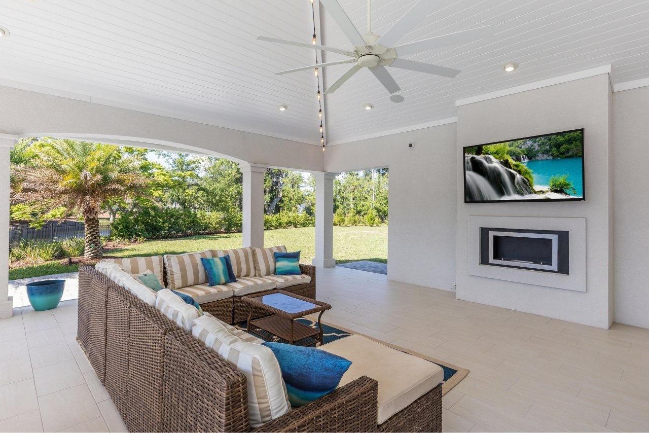 luxury outdoor living area with shiplap ceiling, tv, and fireplace (1)