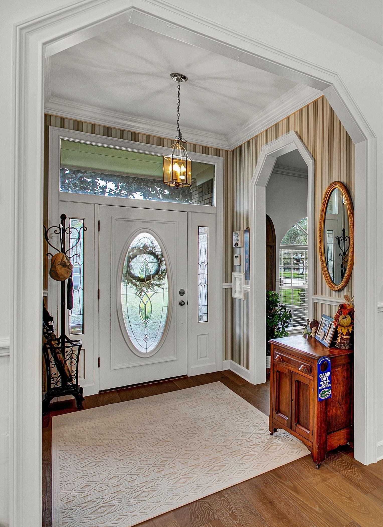 entryway with tray ceiling and vertical stripe wallpaper in jax beach home remodel