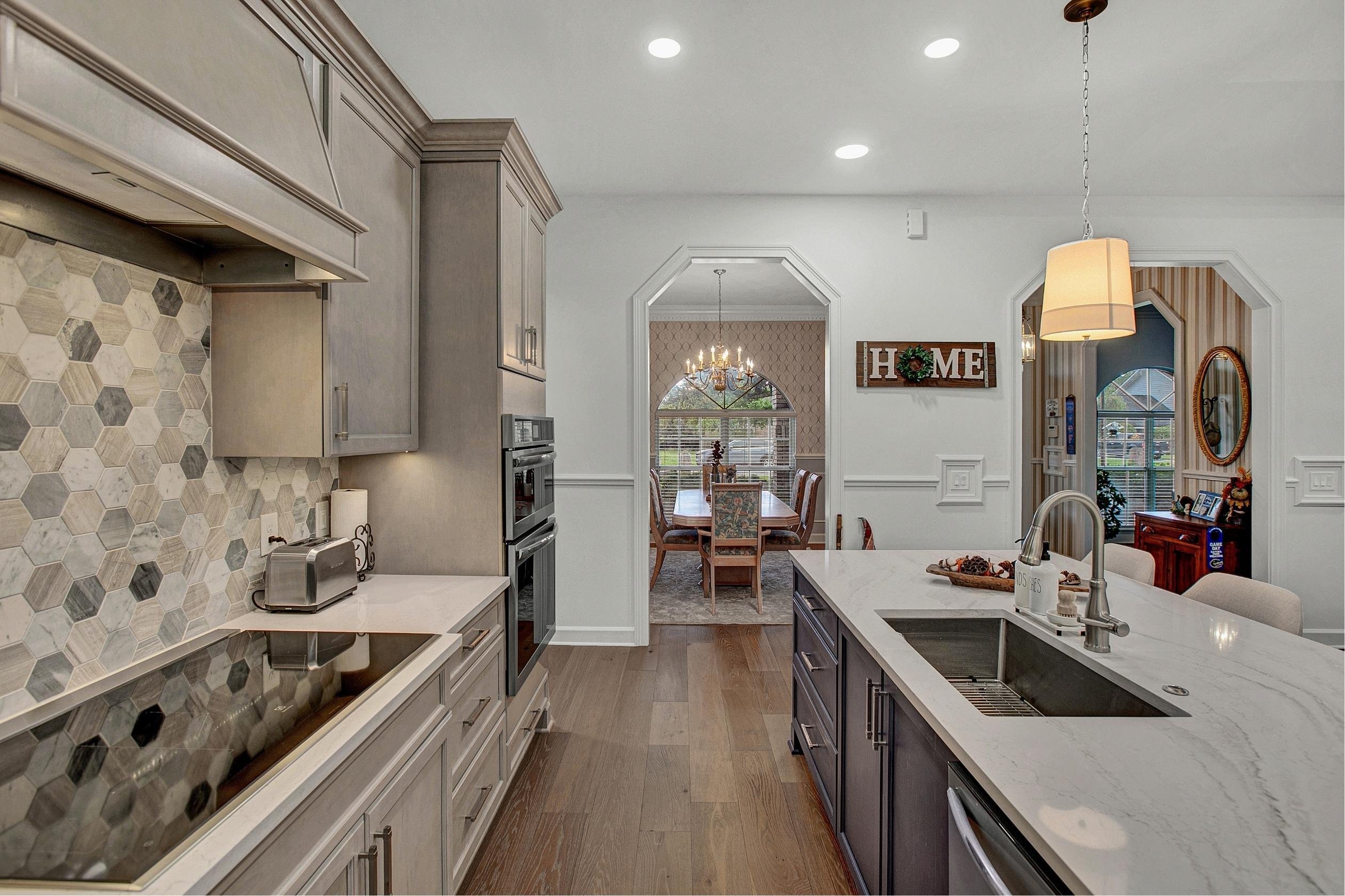 hexagonal backsplash with neutral cabinets in a Jax Beach kitchen renovation