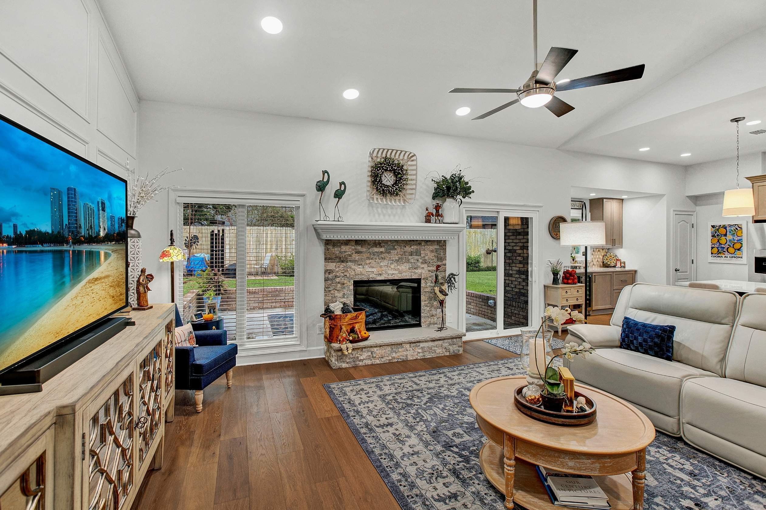 open concept family room with fireplace and outdoor entry