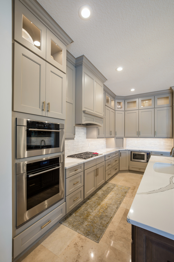 Modern kitchen upgrade in Intracoastal West, FL by BeeTree Homes with smart appliances and marble island