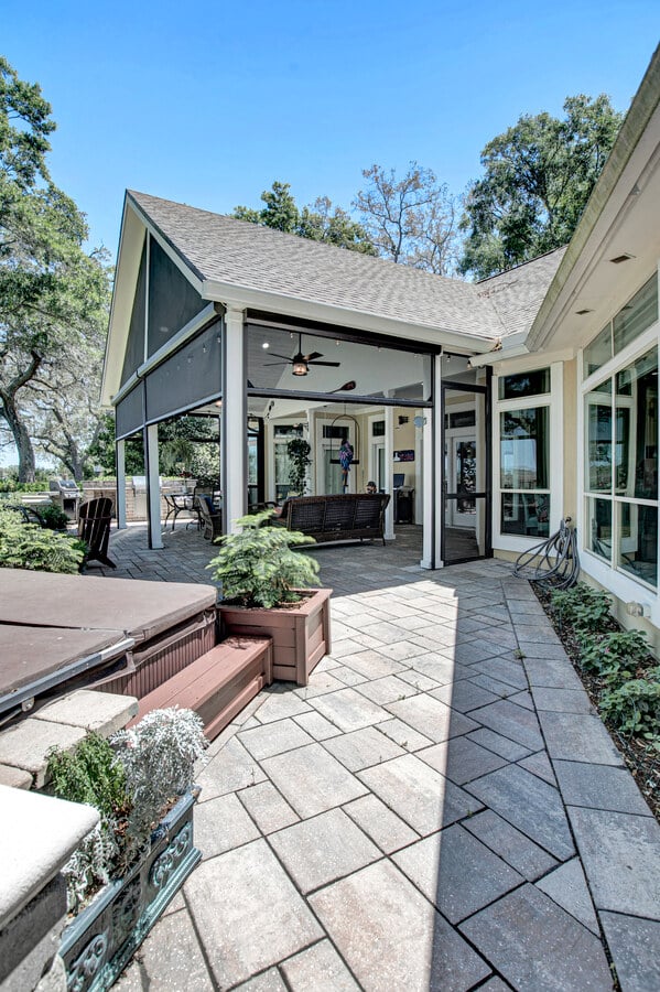 Side entry to screened lanai with hot tub in Jacksonville custom home by BeeTree Homes