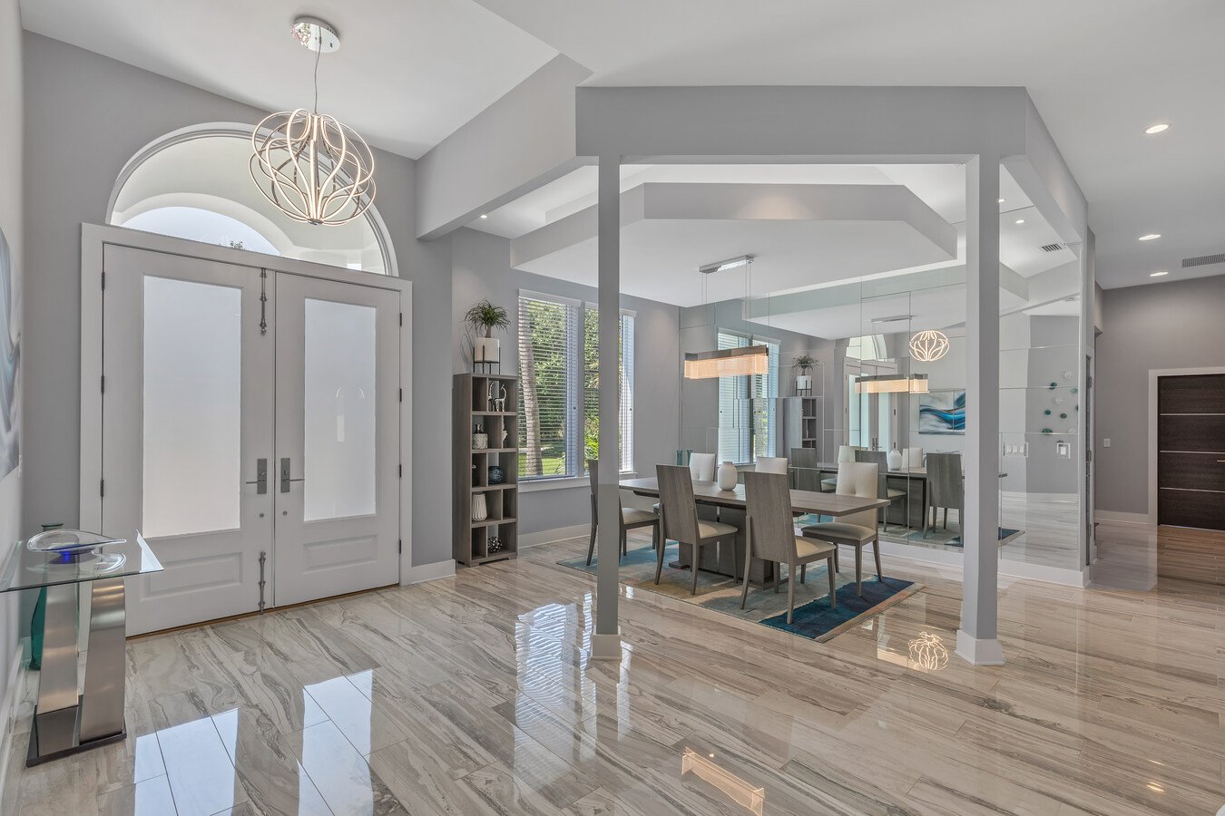 Modern foyer and dining area with architectural ceiling by BeeTree Homes in Jacksonville, FL