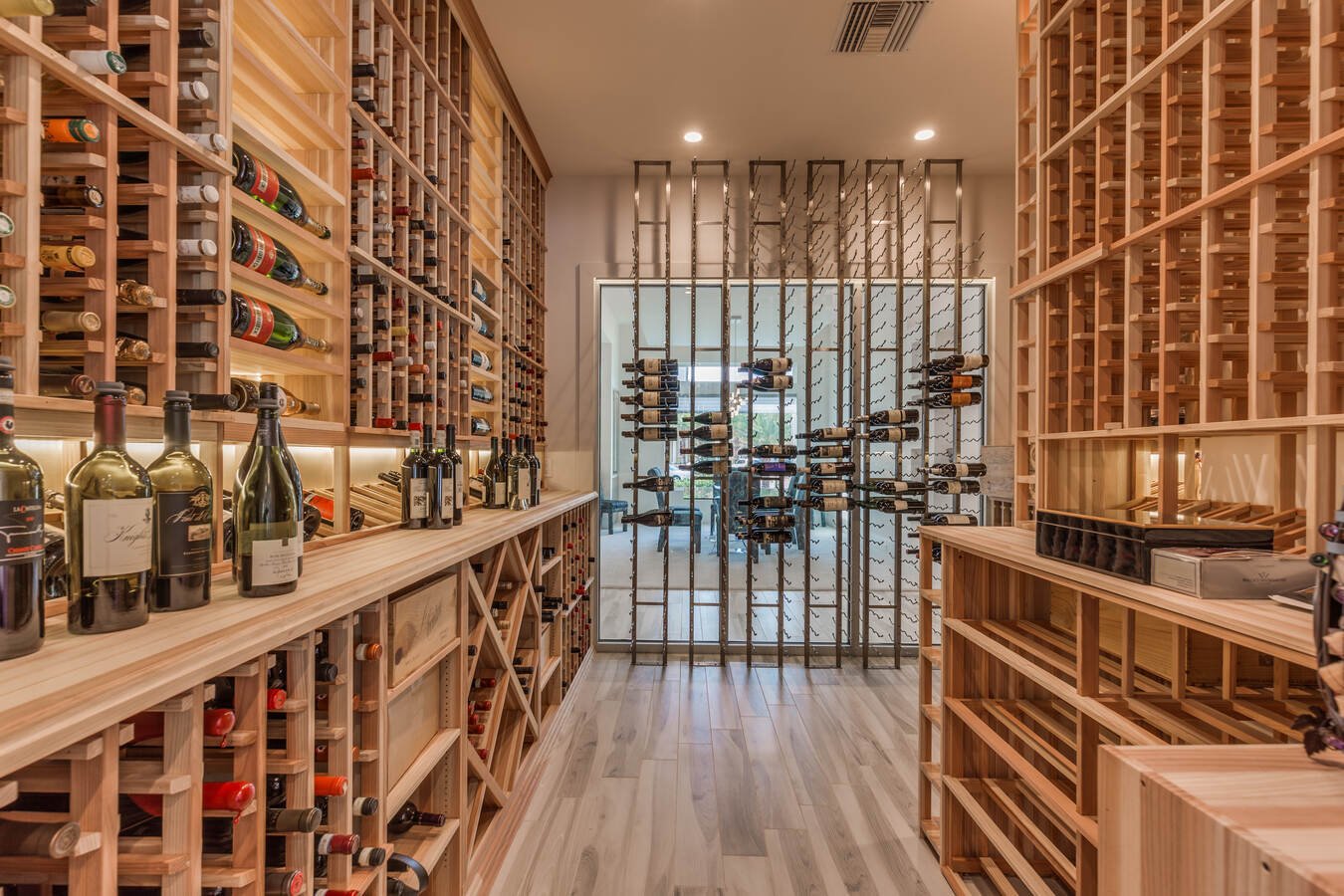 Luxury wine cellar with bottle display in Jacksonville, FL by BeeTree Homes