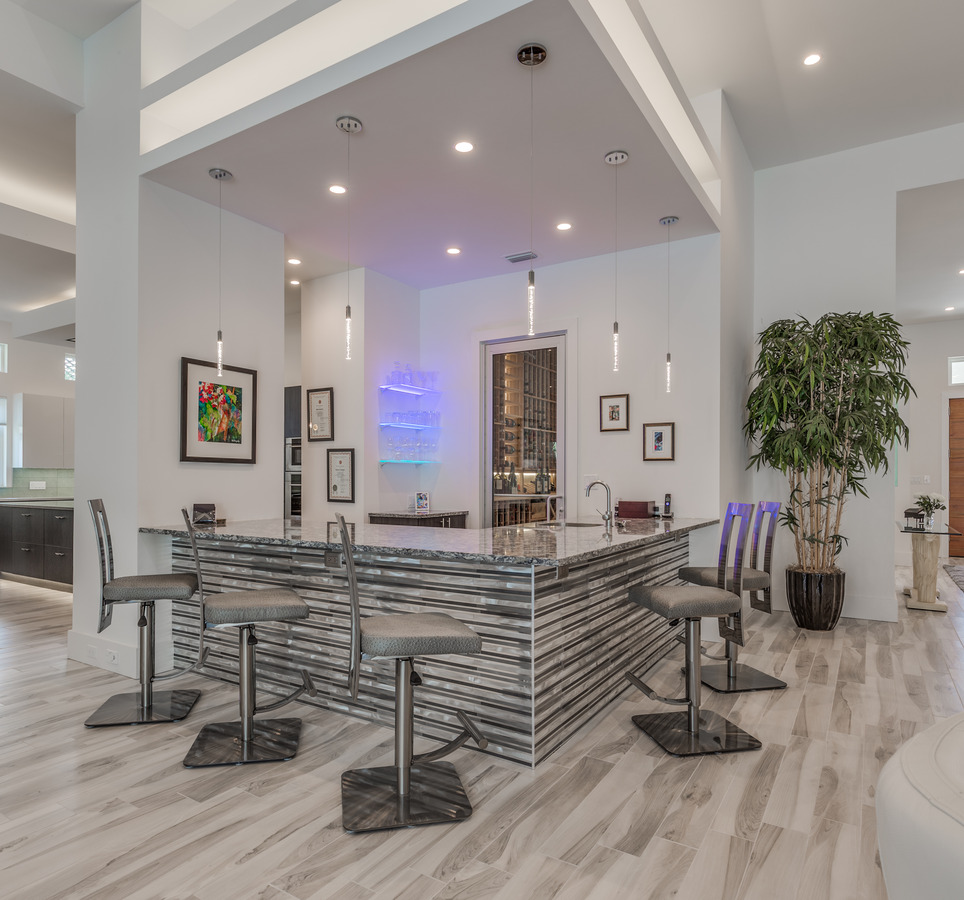 Sleek custom bar with striped paneling designed by BeeTree Homes in Jacksonville, FL