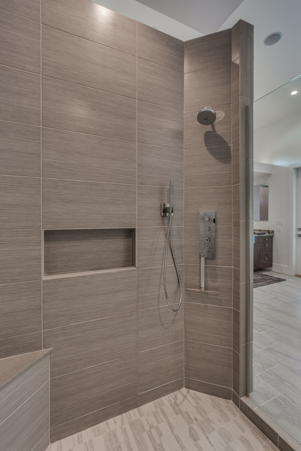Sleek custom walk-in shower by BeeTree Homes in a Jacksonville, FL luxury bathroom