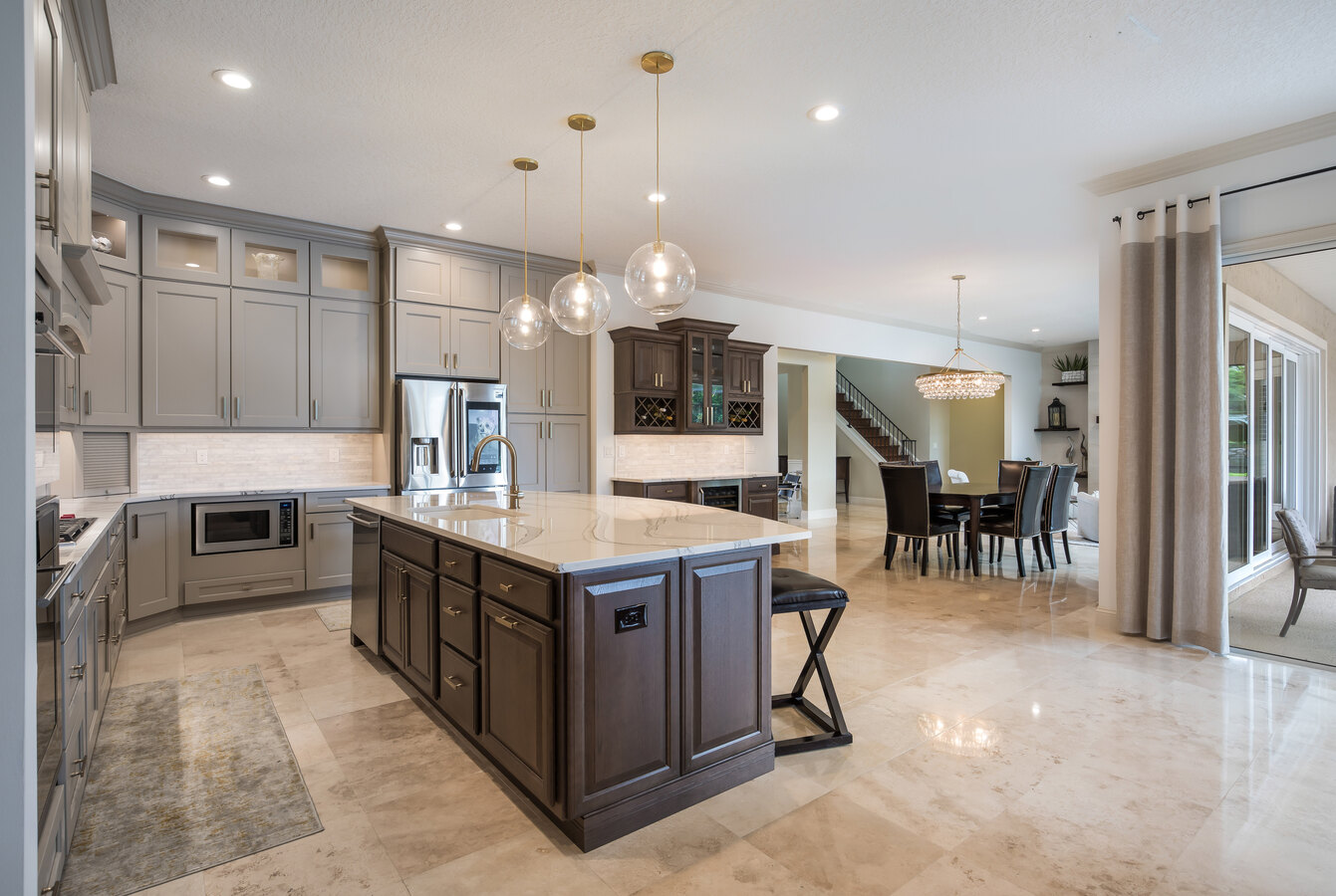 Spacious kitchen-dining layout with natural lighting and luxury finishes by BeeTree Homes in Jacksonville FL