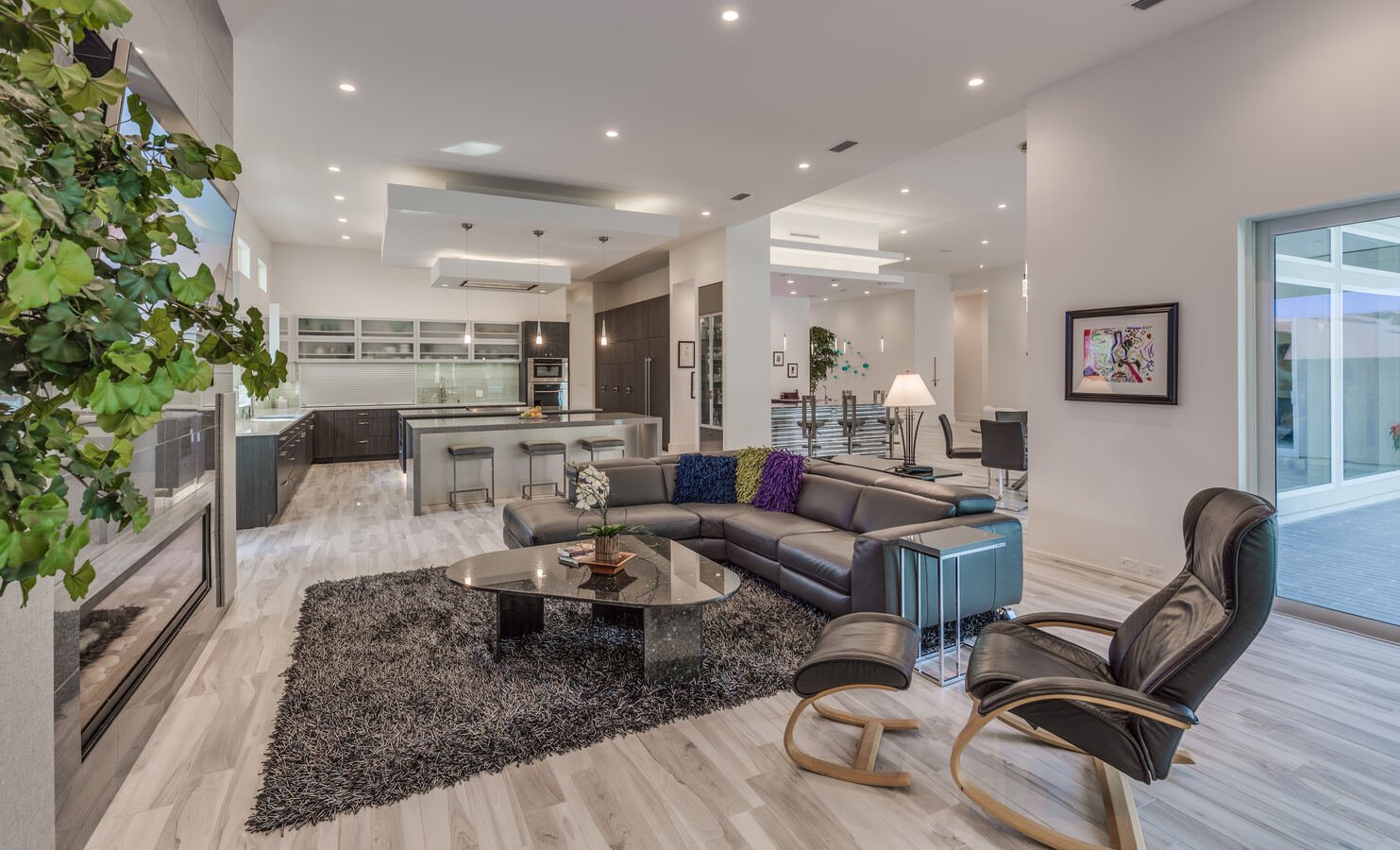 Spacious modern living space with island kitchen and sectional sofa by BeeTree Homes in Jacksonville, FL